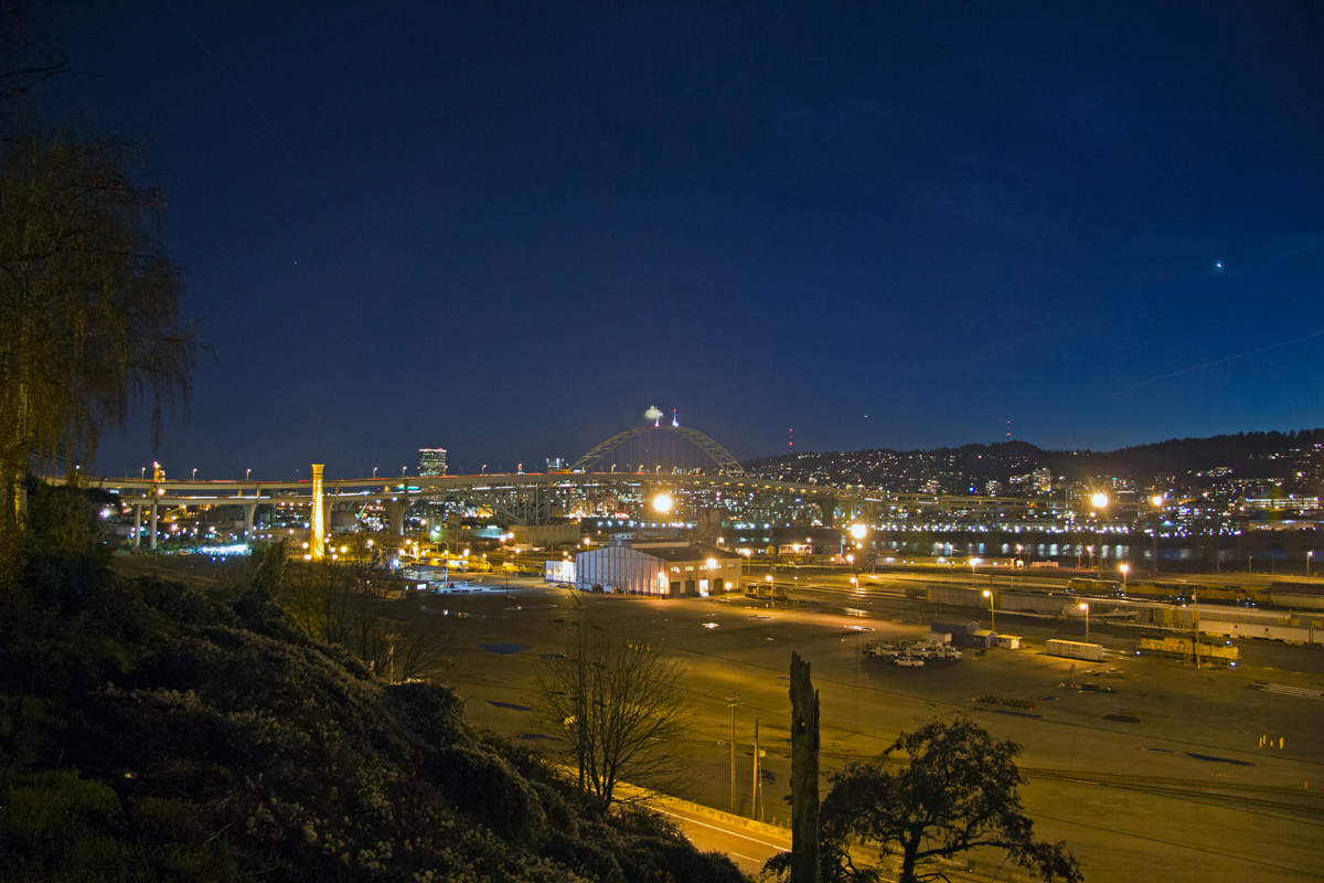 Portland, OR: Union Pacific Albinas Yard with Fremont Bridge and downtown in the background at sundown.