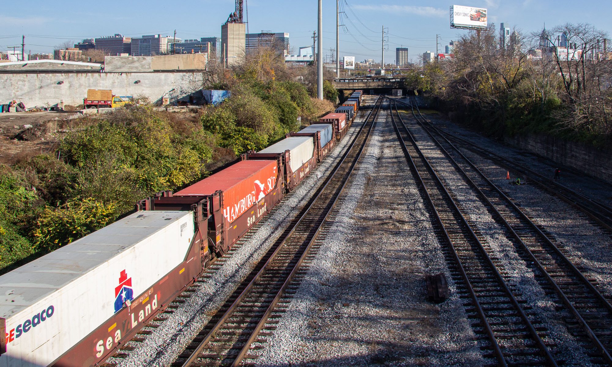 This article is about Docker containers, but here are some shipping containers on railcars. Philadelphia, PA, 2011.