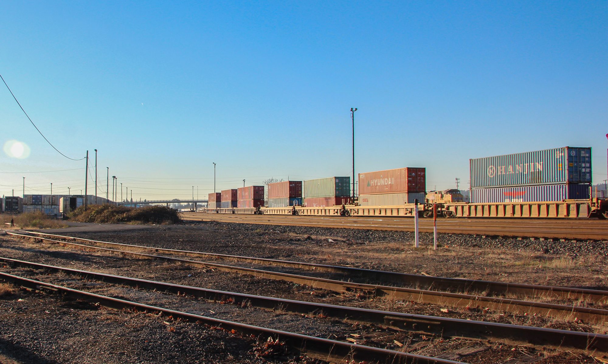 This article is about Docker containes, but here are some shipping containers on railcars. Portland, OR, 2011.